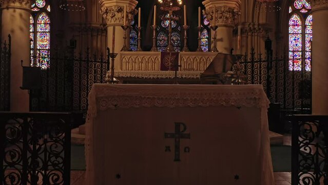 Church altar bathed in the glow of stained glass.