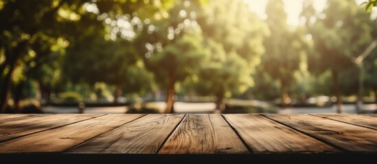 Empty table from old wood in front of blurred background. Perspective of blurry trees in forest