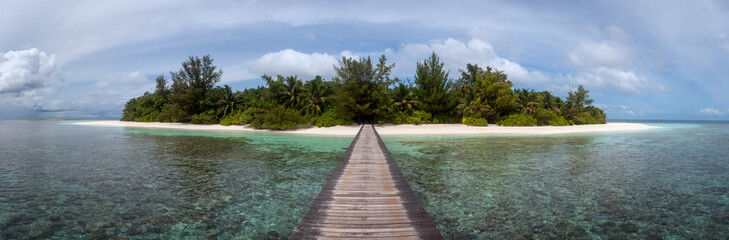 Small Tropical Island Panorama with Wooden Pier or Jetty leading to the tropical Paradise Beach -...