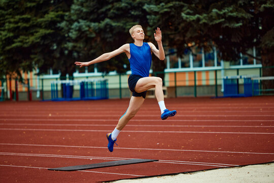 Picture-perfect technique on display as sportsman executes jump. Athletic man, professional sportsman sets new long jump record.