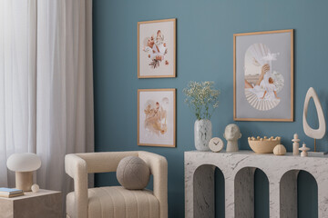 Interior design of aesthetic living room with mock up poster frame, marble console, stylish armchair, pillow, marble lamp, sculpture, blue wall, rug and personal accessories. Home decor. Template.