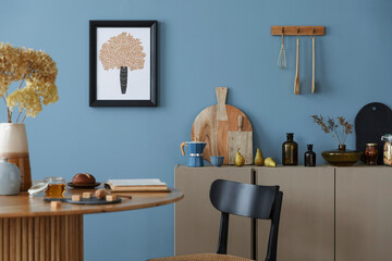Dinning room and kitchen interior with mock up poster frame, round table, rattan chair, beige...