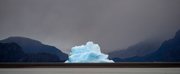 Large iceberg off the glacier at Lago Grey has been blown by the wind close to the beach in Torres del Paine National Park; Patagonia, Chile