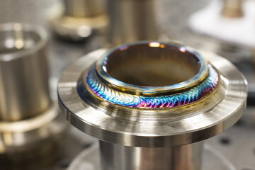 Close-up Freshly welded seam on a stainless flange. Production of metal products from stainless...