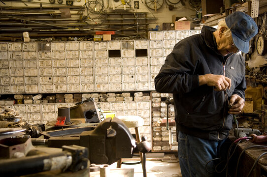 Senior man busy in his workshop; Cortland, Nebraska, United States of America