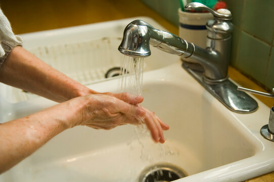 Woman washing her hands at the sink; Lincoln, Nebraska, United States of America