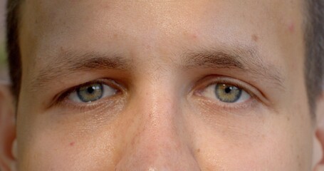 Close-up of male eyes blinks, sense of intimacy and connection between viewer and subject, color of...