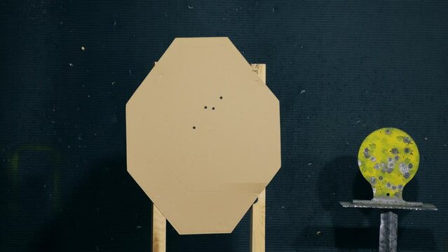 Standard brown paper target for shooting gun, shooter aim metal target on range.