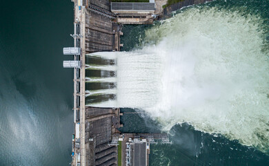 Aerial top down view of water discharge at hydroelectric power plant