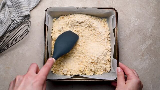 Shortbread raw dough in baking square tin. Baking at home concept.