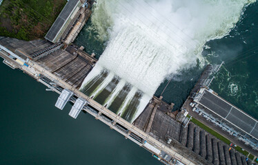Aerial top down view of water discharge at hydroelectric power plant