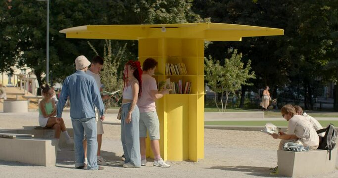 People rest in park, reading books. An open public library is a community resource that provides access to a wide range of books and other reading materials for free.