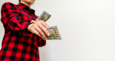 Female person donates one hundred dollars bill.