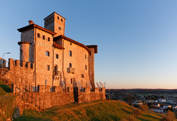 Artegna castle, in Friuli region, Italy, in the sunset light, on the hill above the town