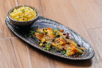 Oven Baked Baby Hammour with fried rice served in dish isolated on table side view of Seafood Main Course arabic food