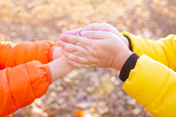 child's hands frozen, mother warms, rub cold palms girl on walk, overall family health strategies,...