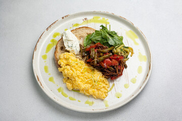 Delicious breakfast - Scrambled eggs, cheese, toast and vegetables