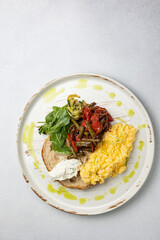 Delicious breakfast - Scrambled eggs, cheese, toast and vegetables