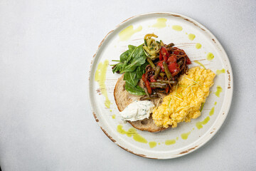 Delicious breakfast - Scrambled eggs, cheese, toast and vegetables