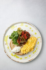 Delicious breakfast - Scrambled eggs, cheese, toast and vegetables