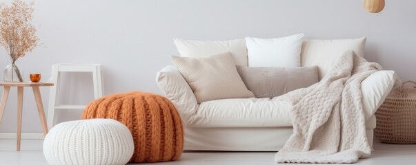 Interior design, detail of bright sofa with pillows and a warm blanket
