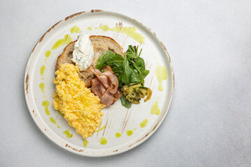 Delicious breakfast - Scrambled eggs with cheese, toast and meat