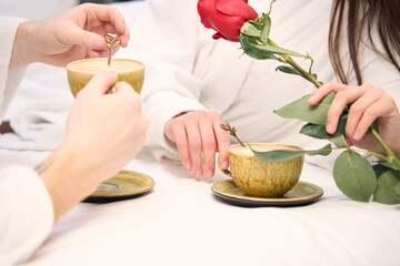 Loving woman and man spending time together in bed