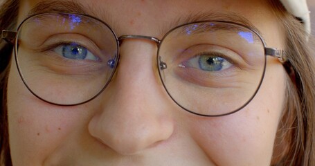 Close-up woman eyes in glasses, sense of connection between viewer and subject, blue color of the...