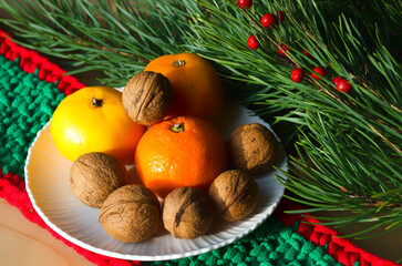 Tangerines and walnuts on a New Year's background.