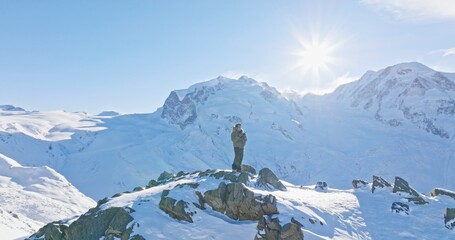 Panoramic landscape of Young asian man standing on top of the famous Gornergrat observatory...