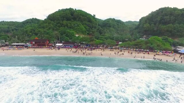 Aerial view of Indrayanti beach, Yogyakarta - Indonesia, beauty of indonesian beach, many people travel to the beach