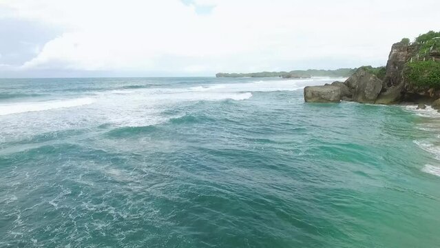 Aerial view of Indrayanti beach, Yogyakarta - Indonesia, blue ocean of indonesian beach, many people travel to the beach