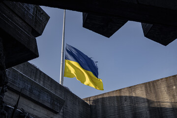 Kyiv, Ukraine. November 30, 2023: the blue sky and the flag of Ukraine can be seen through the...