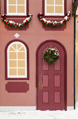 Decorative wall of old European house Christmas wreath on door....