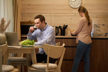 Busy male and woman having coffee break