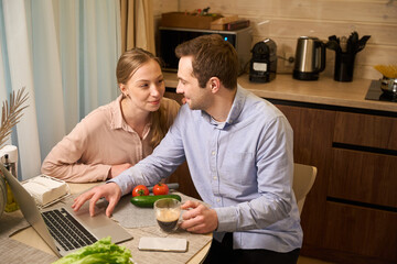 Cute couple having coffee break at home office