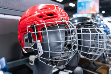 Blue and Red Hockey Helmets with Visors Arranged Neatly on the Shelf