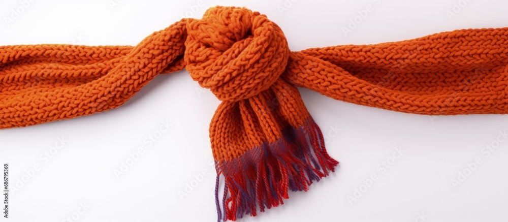 Poster Handcrafted winter scarf against white backdrop Copy space image Place for adding text or design