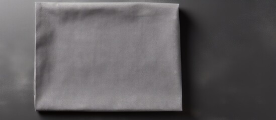 Gray kitchen napkin isolated on table folded cloth for mockup on a flat lay Copy space image Place for adding text or design
