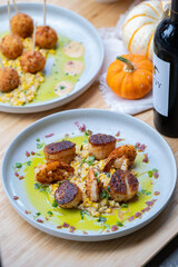Seared scallops and shrimp on a bed of succotash.