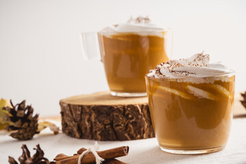 Pumpkin spice latte with whipped cream and cinnamon, warmer autumn and winter hot drink