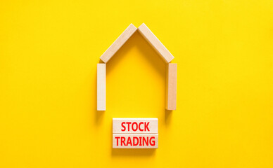 Fototapeta na wymiar Stock trading symbol. Concept words Stock trading on beautiful wooden blocks. Beautiful yellow table yellow background. House model. Business stock trading concept. Copy space.