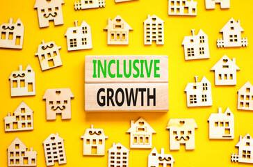 Inclusive growth symbol. Concept words Inclusive growth on beautiful wooden blocks. Beautiful yellow table yellow background. House model. Business inclusive growth concept. Copy space.