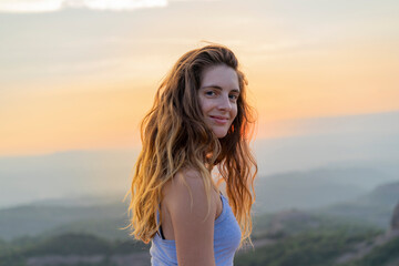 Fototapeta na wymiar Woman watching sunset in the mountains