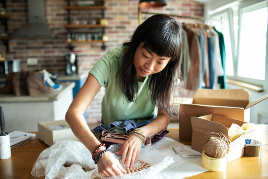 Entrepreneur Woman Preparing Packages for Shipping in Home Office