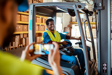 Happy Warehouse Worker Operating a Forklift While Being Photographed