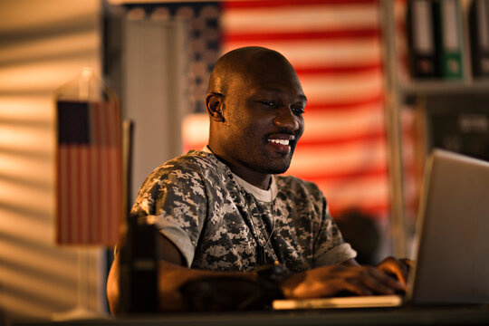Smiling young soldier working in military base