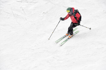 Fototapeta na wymiar Georgia, Caucasus, Gudauri, man on a ski tour riding downhill