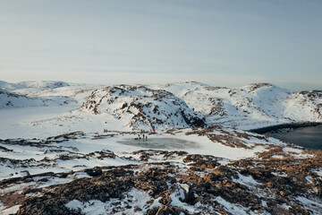 Teriberka's ice beret. Arctic Circle. Winter snowy beach with rocks.