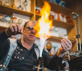 Glass blower forming melting glass